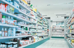 Cropped shot of fully stocked shelves in an aisle of a pharmacy