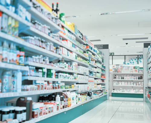 Cropped shot of fully stocked shelves in an aisle of a pharmacy